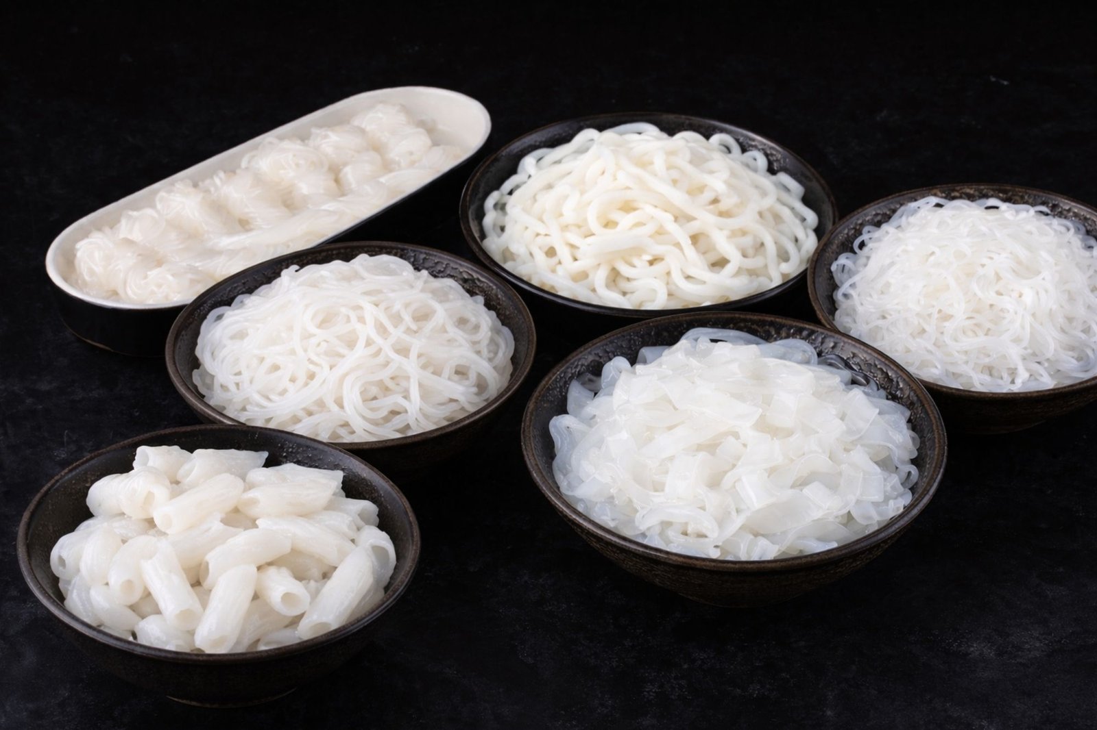 Various shapes of konjac noodles including konjac udon, spaghetti, angel hair, fettuccine, knot, and penne for OEM private label food manufacturing